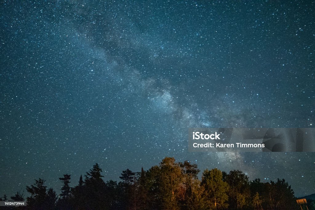 The great Milky Way Galaxy Nighttime view of the Milky Way against the backdrop of trees in the Adirondack Mountains Astronomy Stock Photo