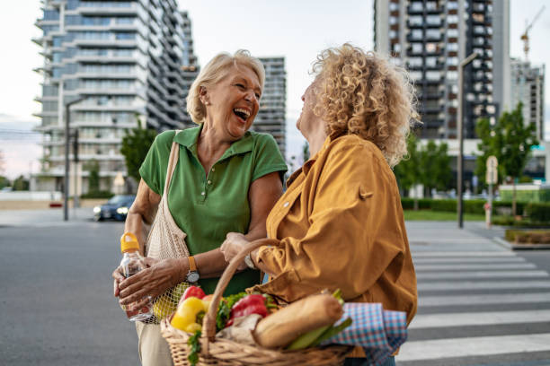 istock Two women laughing on the street 1412474665