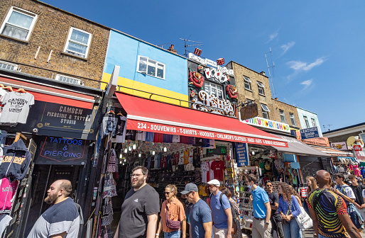 Many shoppers walking on the sidewalk outside Gift Shop in Camden Town at Borough of Camden, London