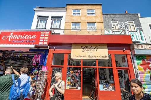 Gohil's Leather Goods Shop at Camden Town in Borough of Camden, London, with people walking outside. This shop was founded in 1966 and has provided boots to George Harrison, Eric Clapton, Syd Barrett and the rest of Pink Floyd. The band mentions the shop's name in the song 'Nobody Home' on 'The Wall' album.