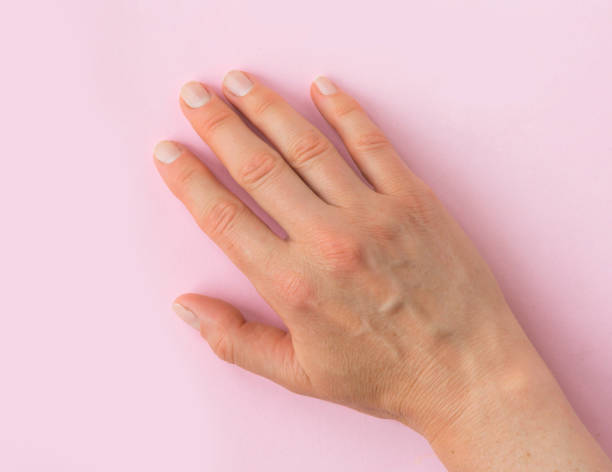 Right female adult hand on a pink background Right female adult hand on a pink background right handed stock pictures, royalty-free photos & images