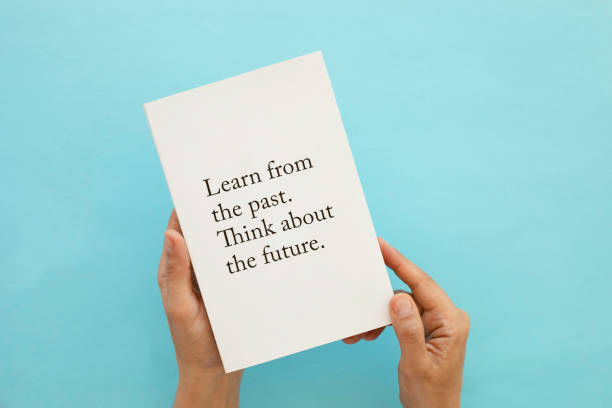 istock Woman Holding Book Against Blue Background 1412480703