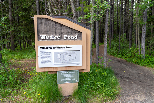 Kananaskis Country, Alberta, Canada - July 8, 2022: Sign and map for Wedge Pond, a small lake for day use and hiking