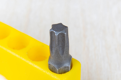 Close-up of a Torx type screwdriver bit in a yellow bit holder