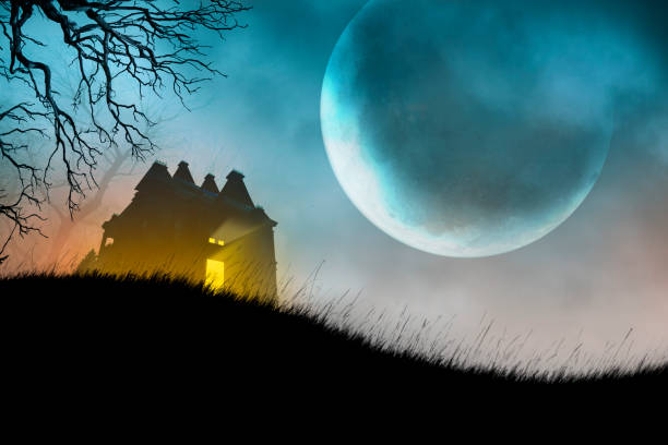 istock Haunted House On Hillside in Front of Large Moon 1412484498