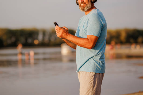 istock Close up of Active man casually running at the beach 1412484719