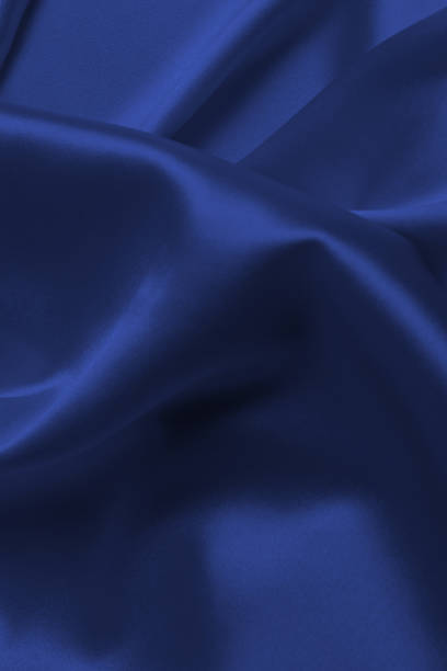 istock Red silk or satin luxury fabric texture can use as abstract background. 1412487361