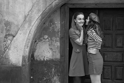 happy and lucky to have a sister. two girls outdoors in black and white clothes. good and bad. obedient and harmful. fraternal twins teen sisters