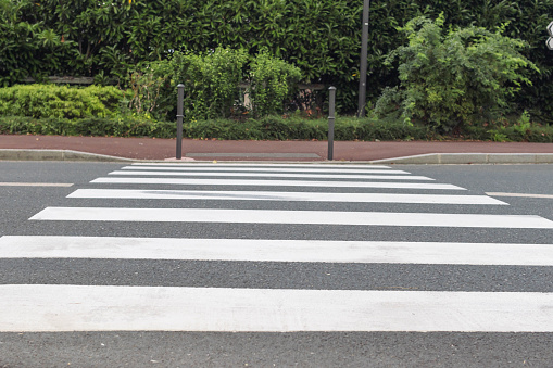 pedestrian crossing on the road for safety when people cross the street, pedestrian crossing on the repaired asphalt road, pedestrian crossing on the street for safety. High quality photo