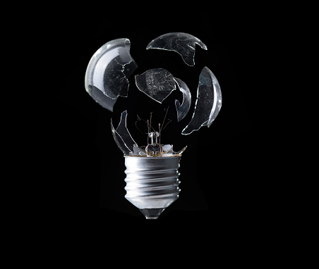 Broken lightbulb isolated on black, idea explode