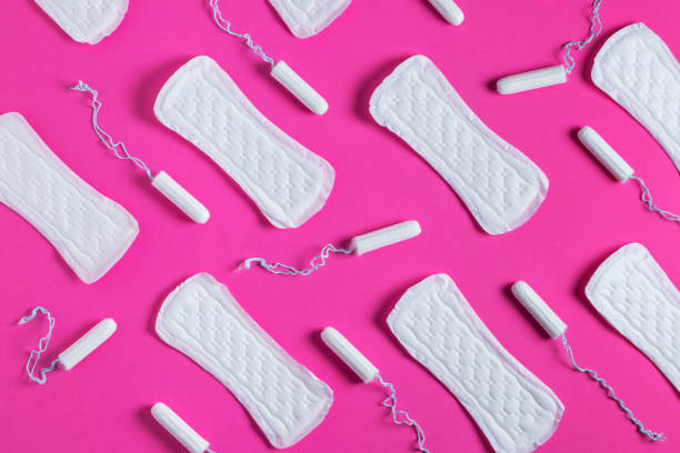 Tampons, feminine sanitary pads pattern on pink background. Hygiene care during critical days. Menstrual cycle. Tampons, feminine sanitary pads pattern on pink background. Hygiene care during critical days. Menstrual cycle. Caring for women's health. Monthly protection. menstruation stock pictures, royalty-free photos & images