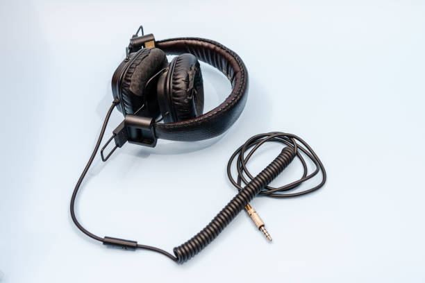istock Black computer earphones (headphones) isolated on white background 1412496914