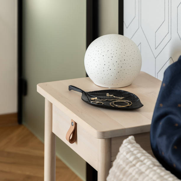 istock Stylish decorations on wooden bedside table, close-up 1412500251
