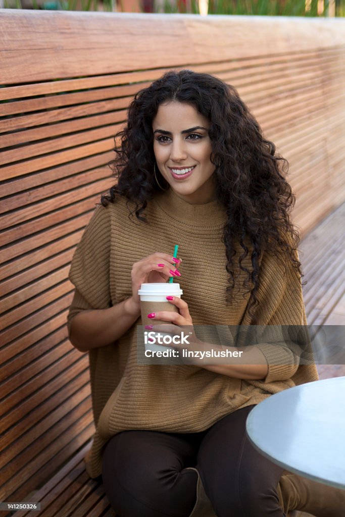Beautiful Middle Eastern woman drinks coffee Beautiful Middle Eastern woman drinks coffee. Arabia Stock Photo