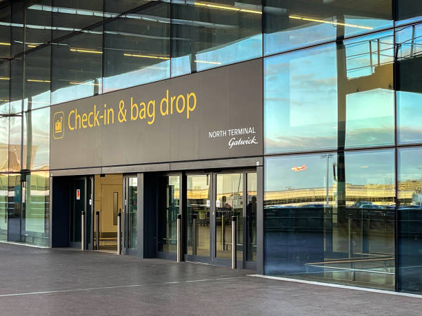 Entrance to the North terminal at London Gatwick airport London, United Kingdowm - May 2022: Sign above the entrance to the departures hall at London Gatwick aiport. gatwick airport photos stock pictures, royalty-free photos & images