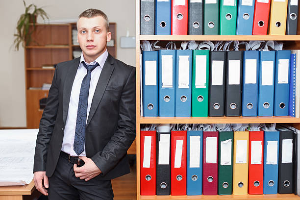 istock Young male businessman executive standing in office 141250617