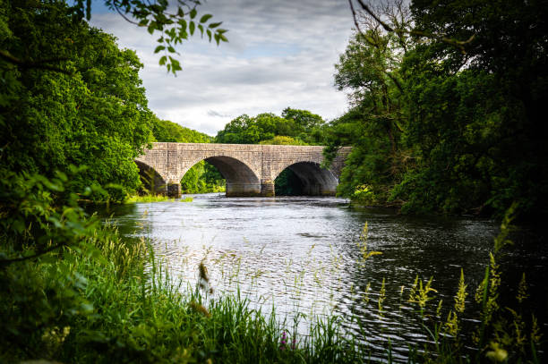 istock Stone built road bridge crossing a river in Scotland 1412506736