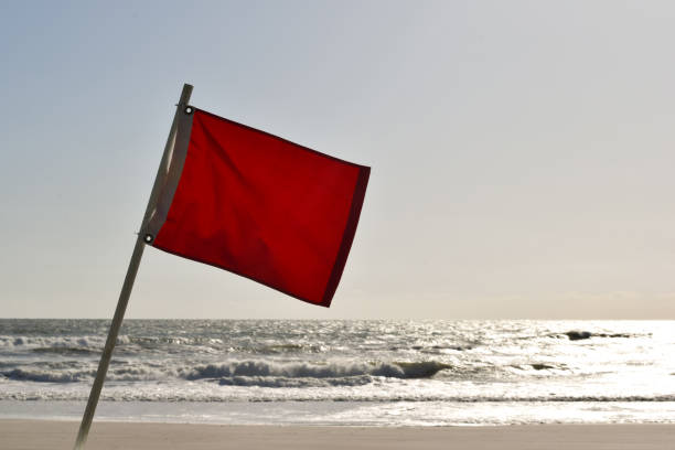 istock red hazard flag on beach indicates danger of high surf and wind 1412507212