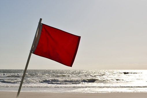 tropical storm hurricane typhoon cyclone ocean beach high surf waves danger red hazard flag