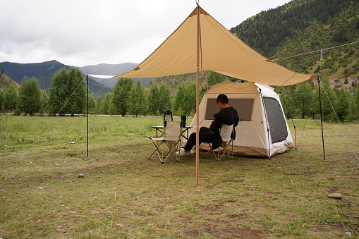 Leisure time for men camping under tents
