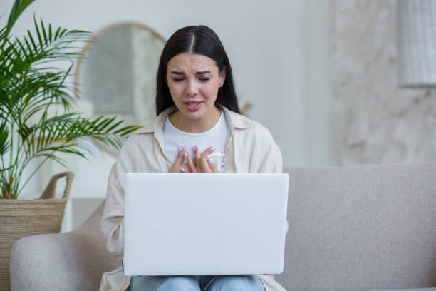 istock Young beautiful woman alone at home in depression crying 1412513635