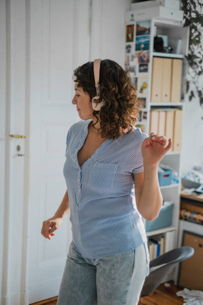 istock woman dancing with headphones 1412514415