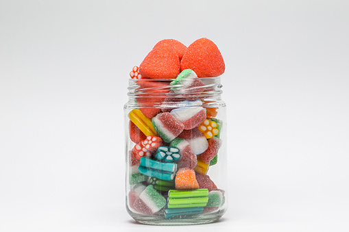 Colored candy.  Sweets for children.  Sweets in a glass jar