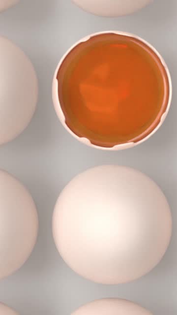 Vertical Half Raw Egg is Surrounded by Bunch of White Eggs on White Surface in 4K Resolution