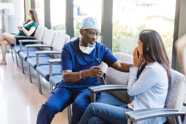 istock Doctor comforts his patient's wife 1412518811