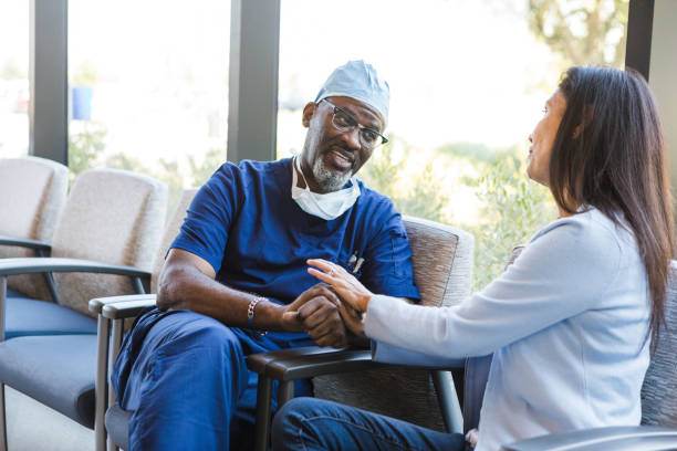 istock Doctor comforts the female patient 1412518827