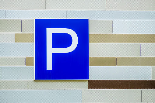 Parking is allowed sign on the wall of an office building close-up