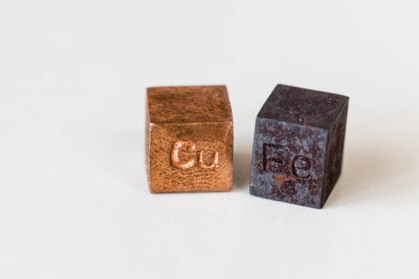 istock Iron and copper cubes with elements names on them on cream background 1412520895
