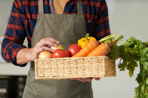 istock Man Holding Basket of Fresh Vegetables 1412521320