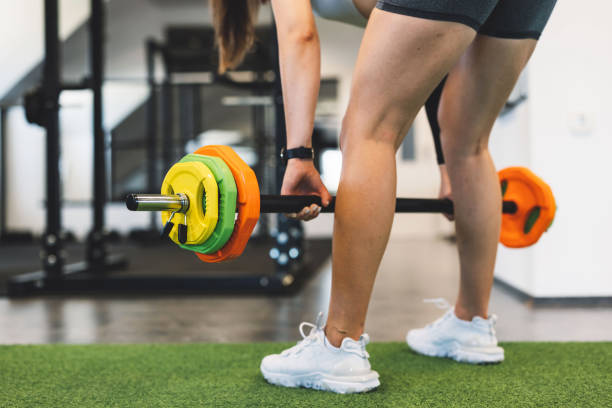 istock Unrecognizable woman lifting barbell 1412522435