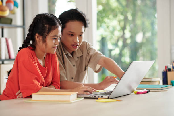 istock Kids Working Together on Laptop 1412525478