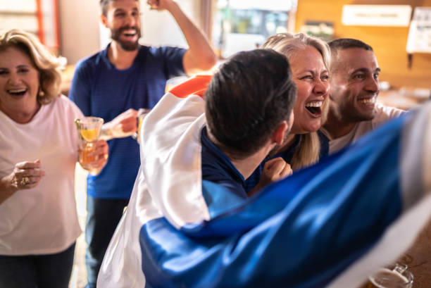 istock French team fans celebrating while watching a match in a bar 1412525767