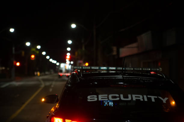 istock Security guard in car patroling at construction site at night  city 1412526711