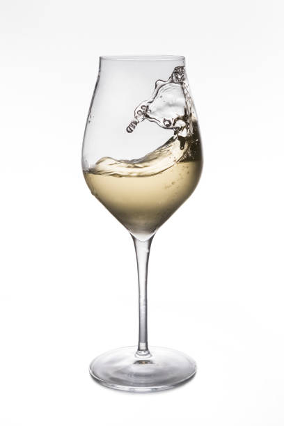istock Glass of white wine on white background 1412526840