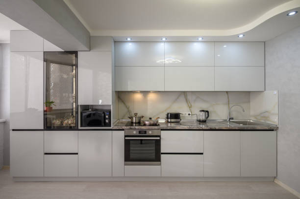 istock Interior of modern trendy white kitchen, front view 1412527089