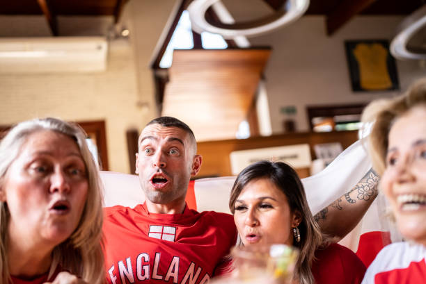 istock Friends watching English team playing in a bar 1412528085