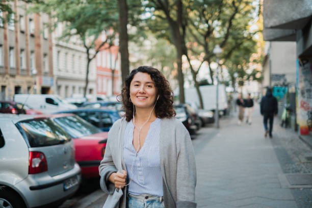 istock Woman walking with earphones 1412528410