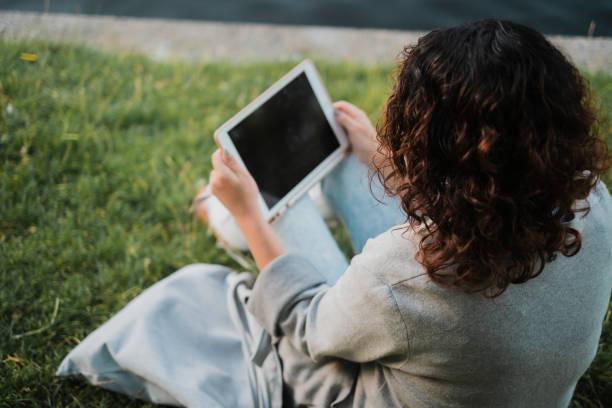 istock Woman looking at her tablet 1412528444