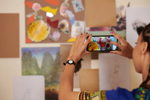 istock Woman Photographing Collage She Made 1412528851