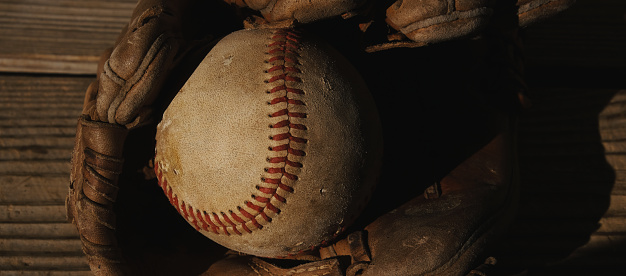 old baseball glove and ball closeup for sport background