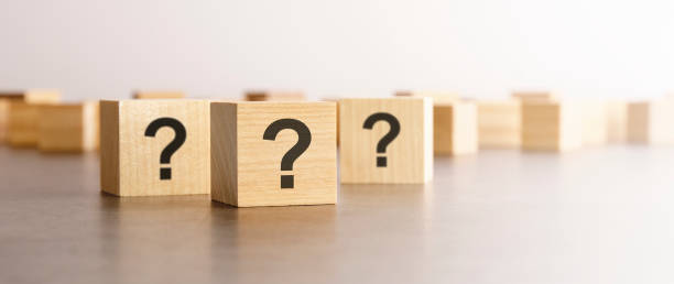 istock cube with question mark on wooden background. space for text 1412531011