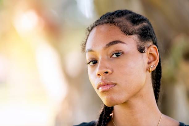 Serious afro-latinx young woman looking at the camera Serious afro-latinx young woman looking at the camera sad gay stock pictures, royalty-free photos & images