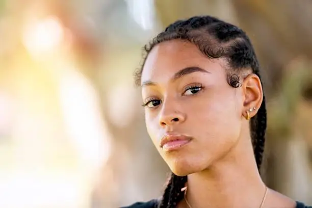 Photo of Serious afro-latinx young woman looking at the camera