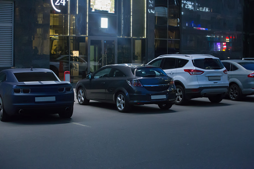 Cars are parked at the nightclub at night