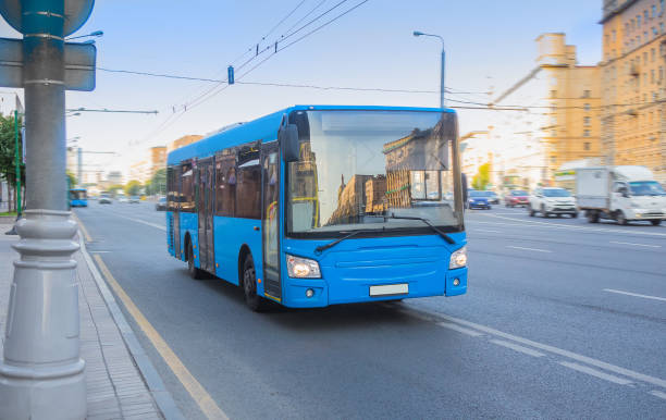 City shuttle bus carries passengers down the street in the city