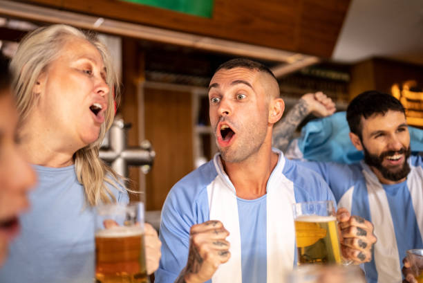 istock Friends watching Argentinian team playing in a bar 1412534496